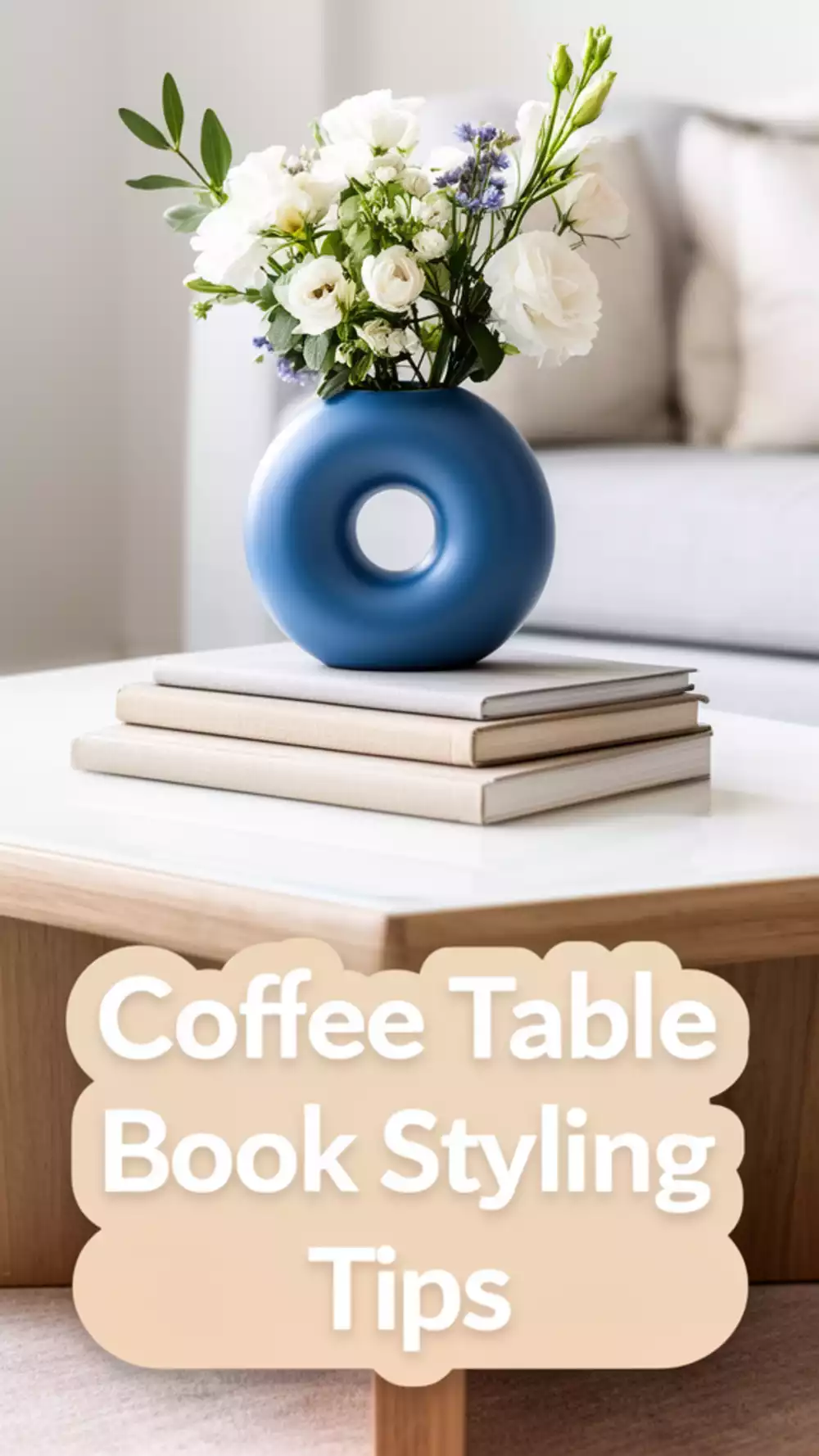 Living Room Stacked Coffee Table Books in a Neutral Tone Under a Simple Vase
