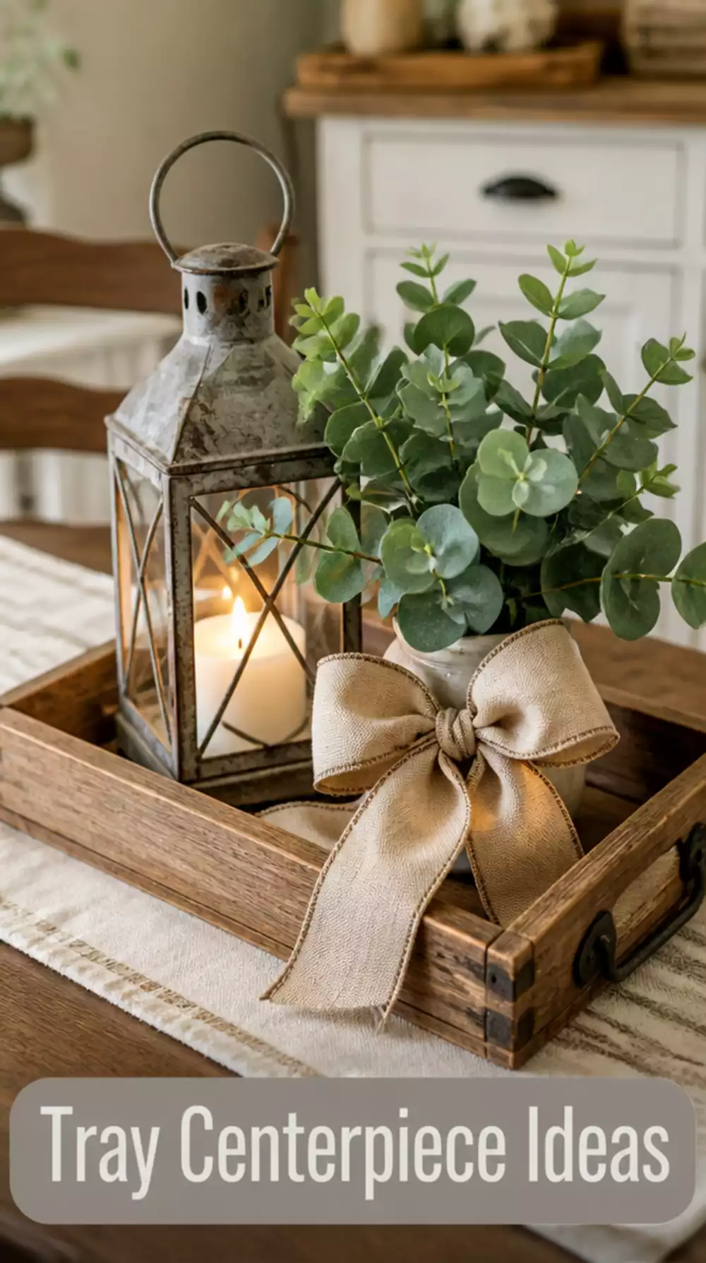 Rustic wooden tray centerpiece with lantern, greenery, and linen ribbon